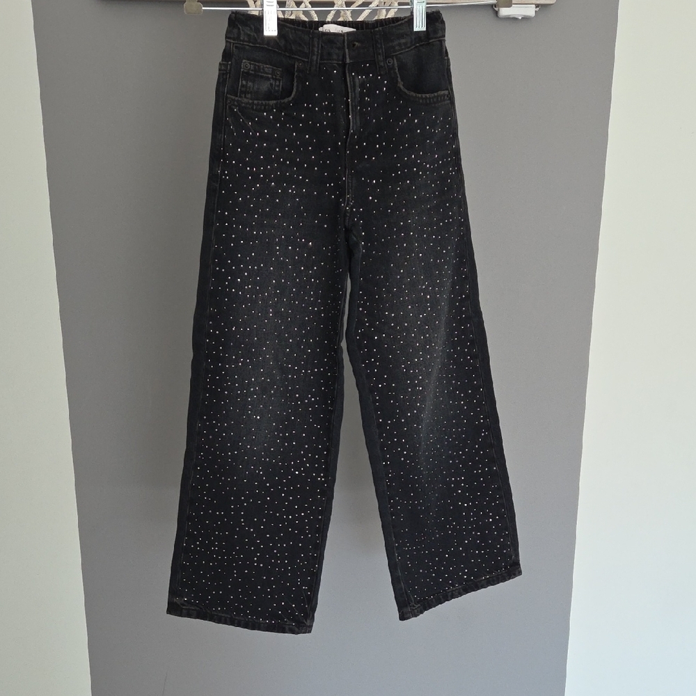 black wide-leg jeans embellished with rhinestones